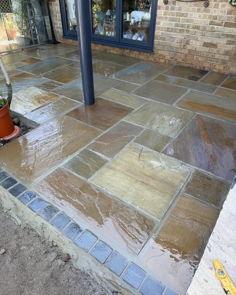 Wet sandstone patio freshly laid and cleaned