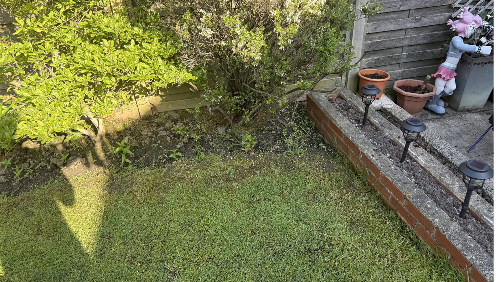 Patio half power washed — the clean/dirty line shows exactly what CPW Gardens can do